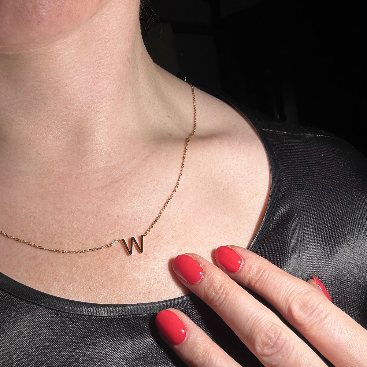 initial W necklace shown worn on model
