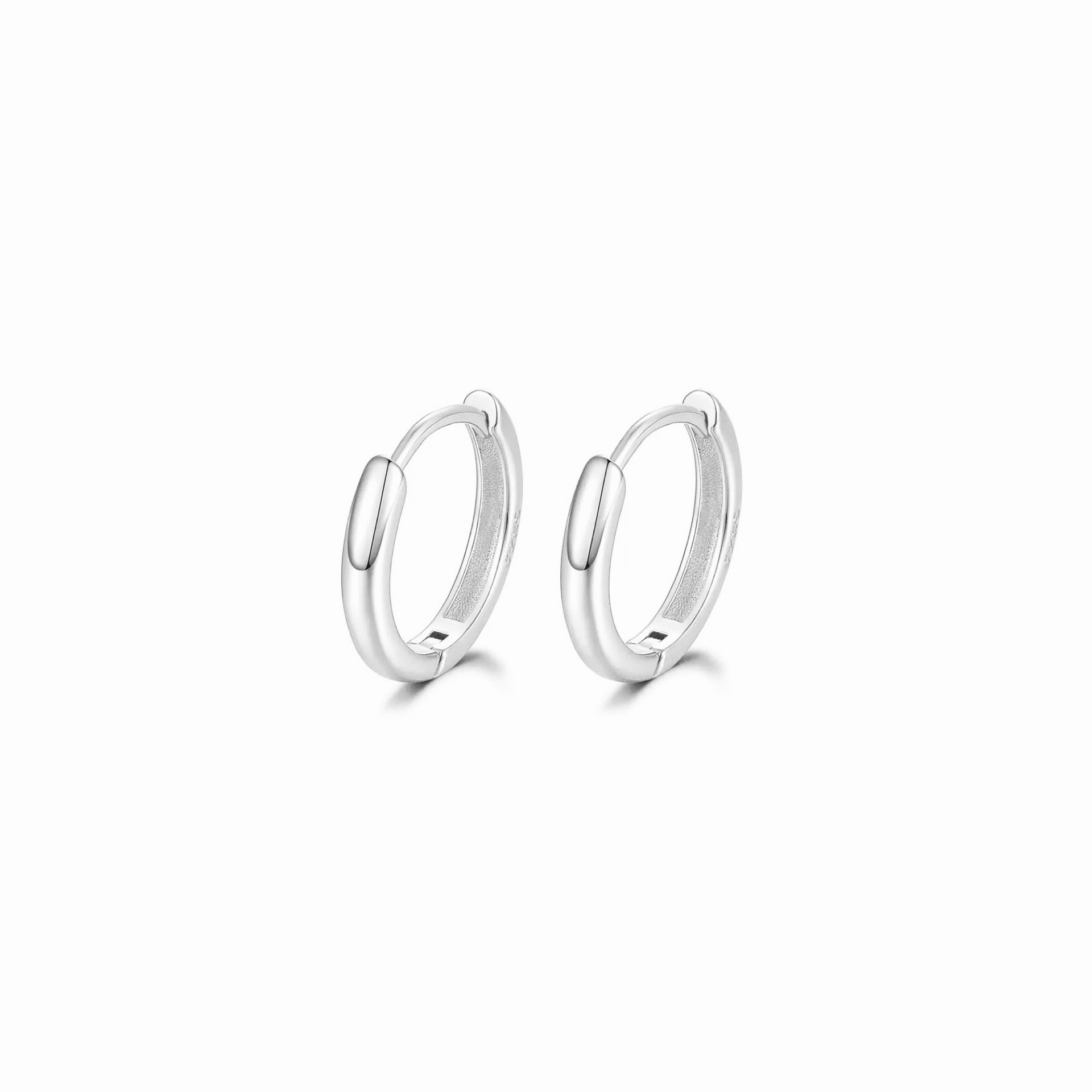 Pair of silver hoop earrings on a white background