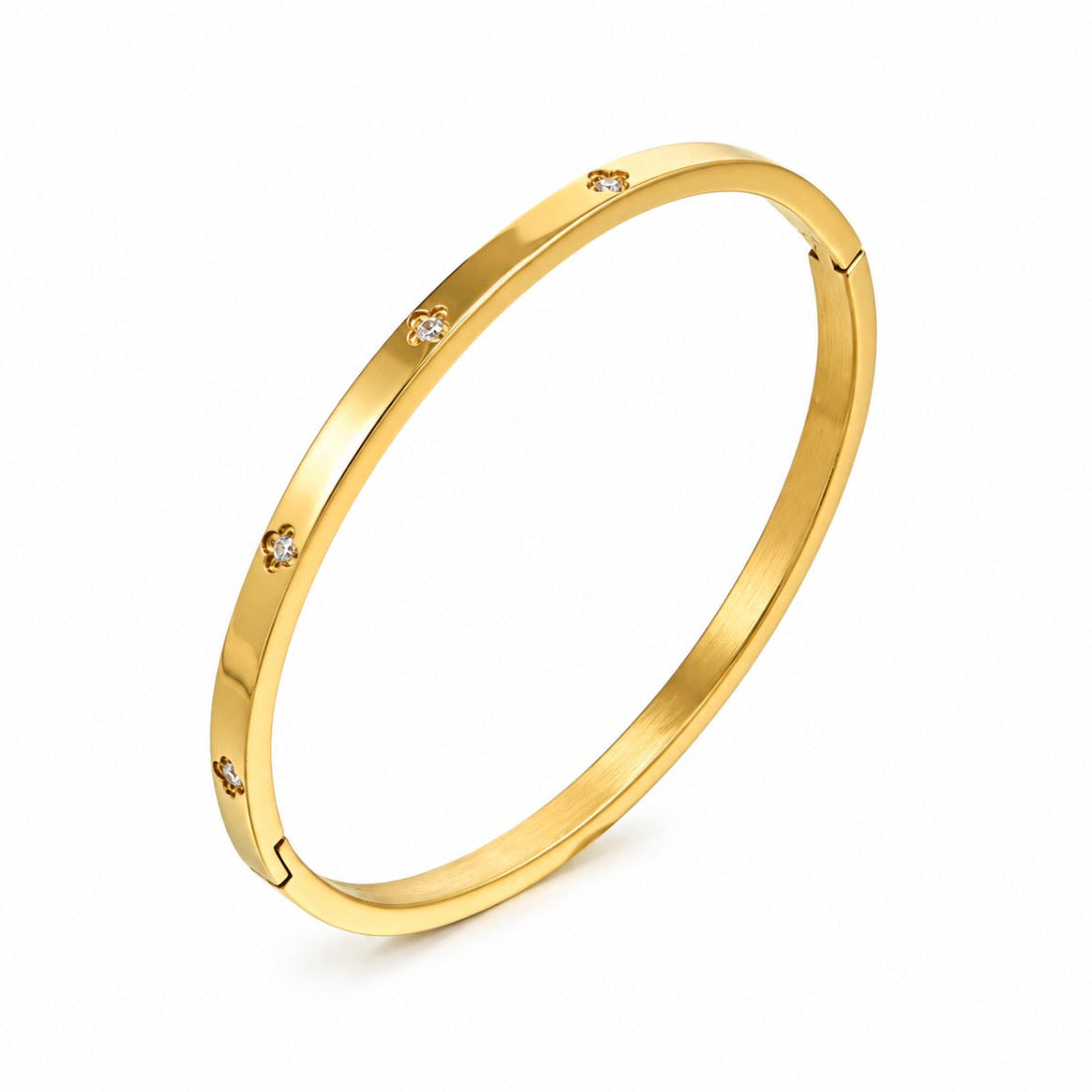 A polished yellow gold bangle bracelet with small, evenly spaced clear gemstones set along the outer band, shown on a clean white background.
