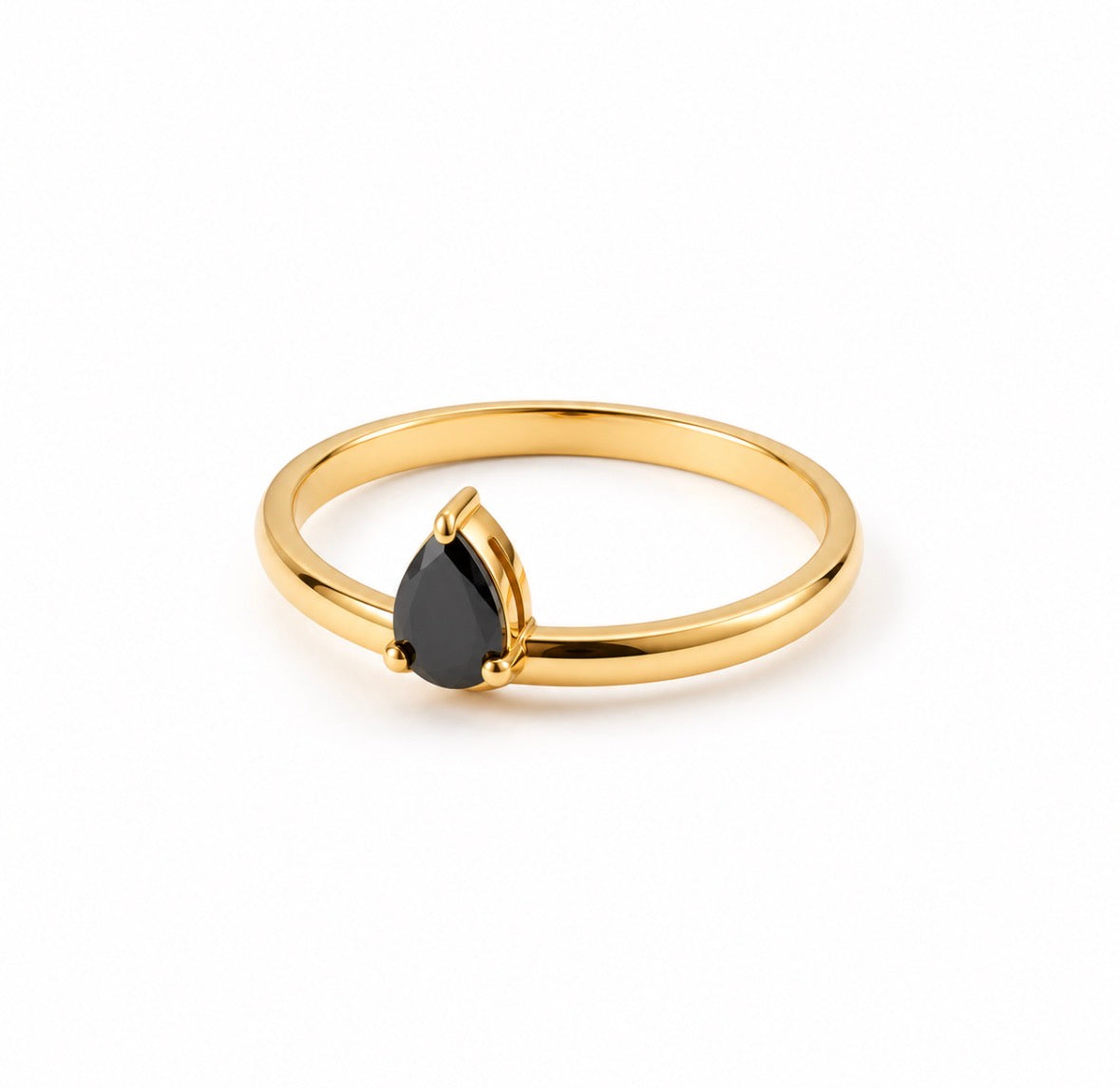 A gold ring featuring a teardrop-shaped black gemstone in a prong setting, photographed on a clean white background.
