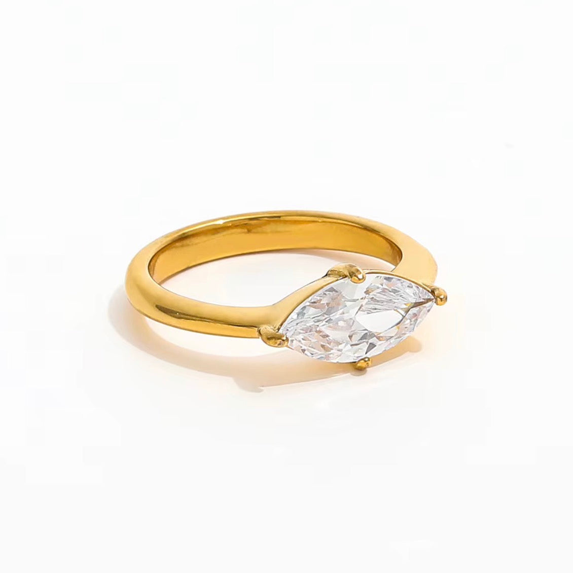 A yellow gold ring featuring a marquise-cut clear gemstone in a four-prong setting, photographed on a clean white background.