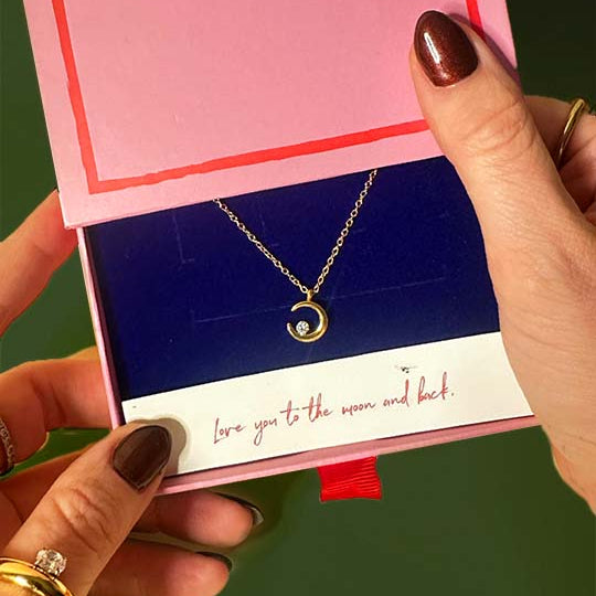 Gold necklace with a heart pendant in a Parker Jewellery Collection box.