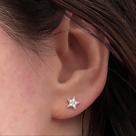 silver star stud earring shown on models ear
