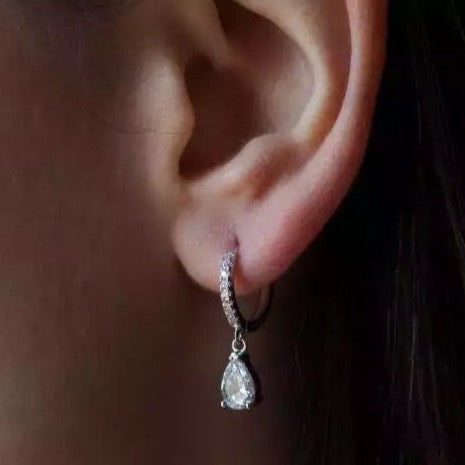 silver pear drop earrings on a model