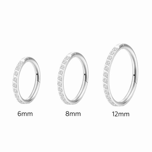 Three silver hoop earrings of different sizes on a white background