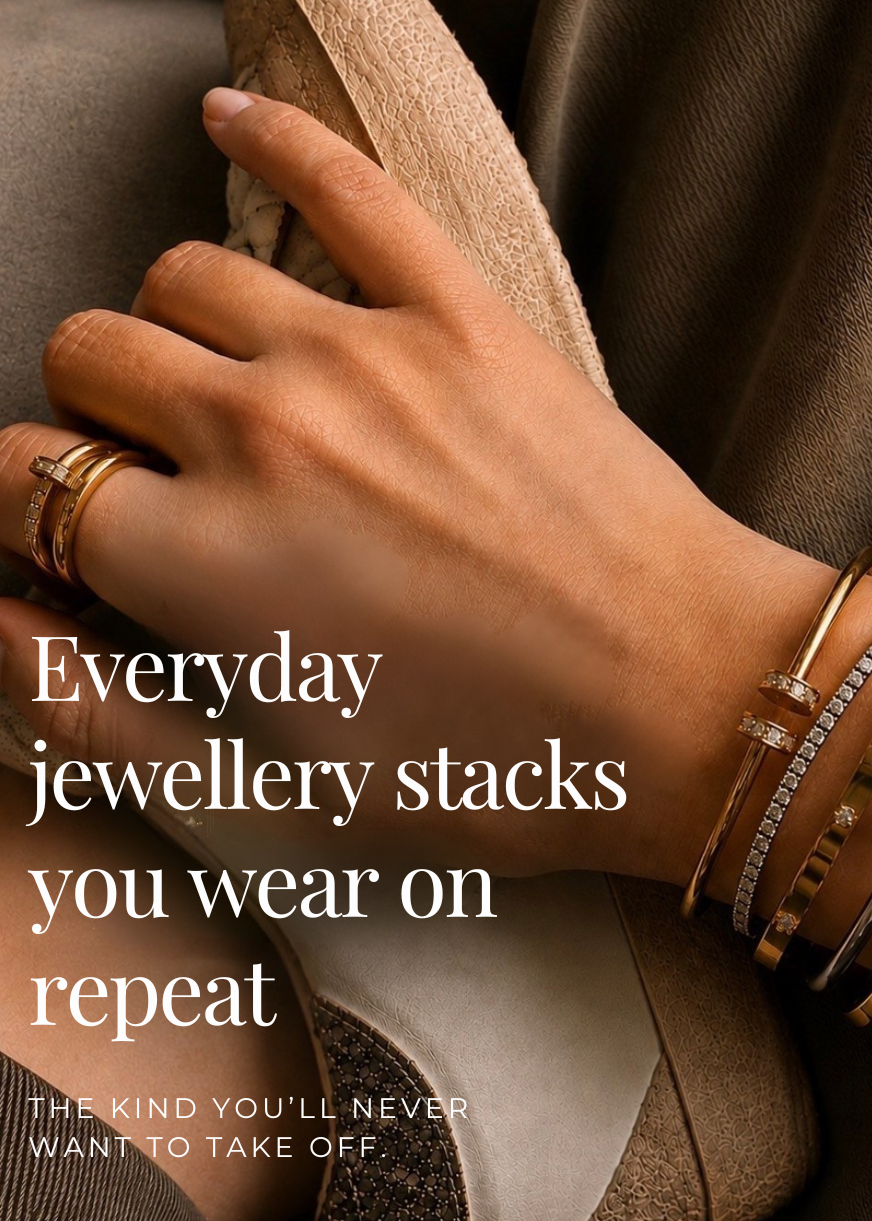 A close-up of a person's hand and wrist wearing multiple stacked gold and silver bracelets with some clear stones, resting on a beige shoe against a brown textured garment. Large white text reads, 'Everyday jewellery stacks you wear on repeat' with smaller text below.