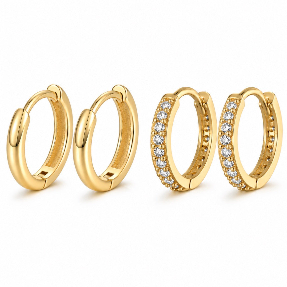 Four gold huggie hoop earrings on a white background, including two plain gold hoops and two gold hoops set with small clear stones.