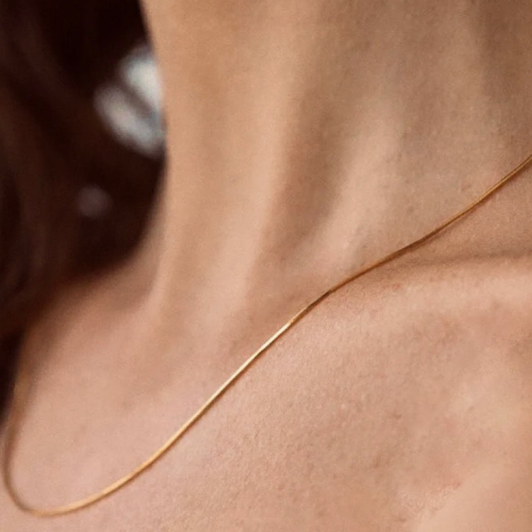 fine gold snake chain worn on model 