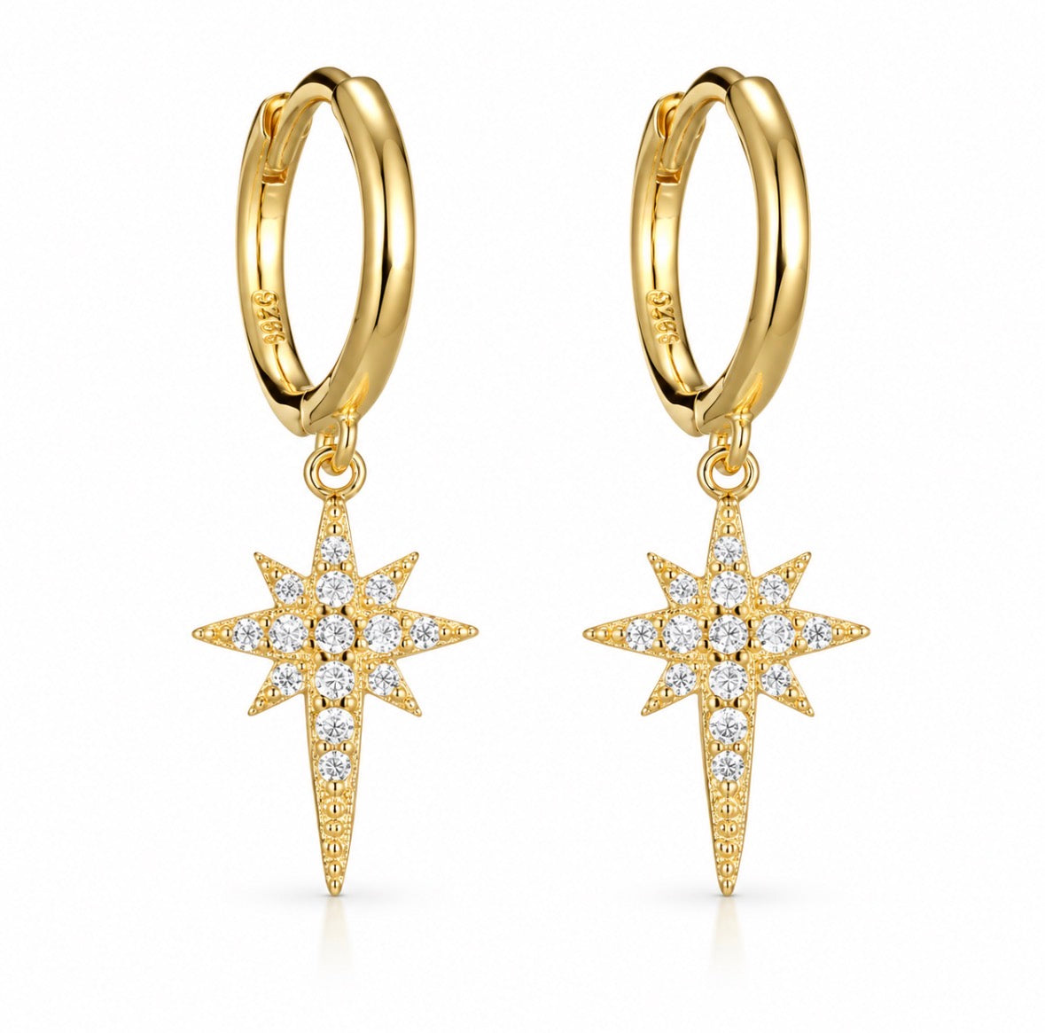A pair of gold huggie hoop earrings with dangling starburst charms set with clear gemstones, shown on a clean white background.