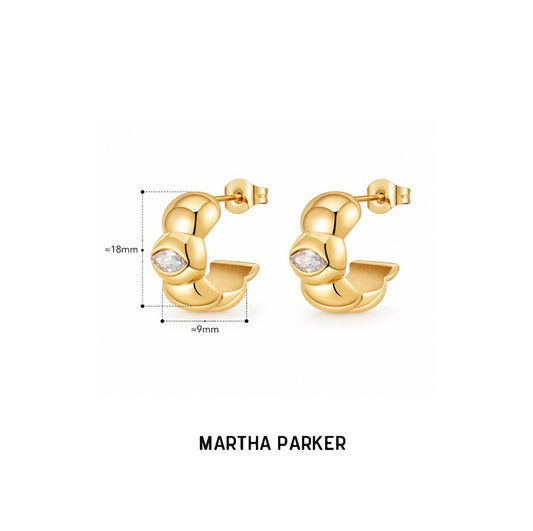 Gold oval bubble hoop earrings with a clear oval gemstone, shown with dimension markings of 18mm height and 9mm width, with the brand name MARTHA PARKER printed below on a white background.