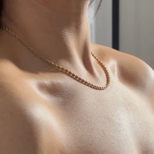 thin gold rope chain shown worn on model 
