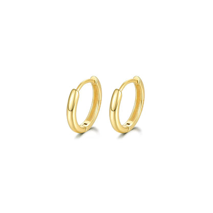 Gold hoop earrings on a white background