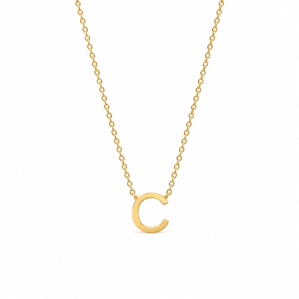A delicate gold chain necklace featuring a polished, open circular letter 'C' pendant, presented on a clean white background.