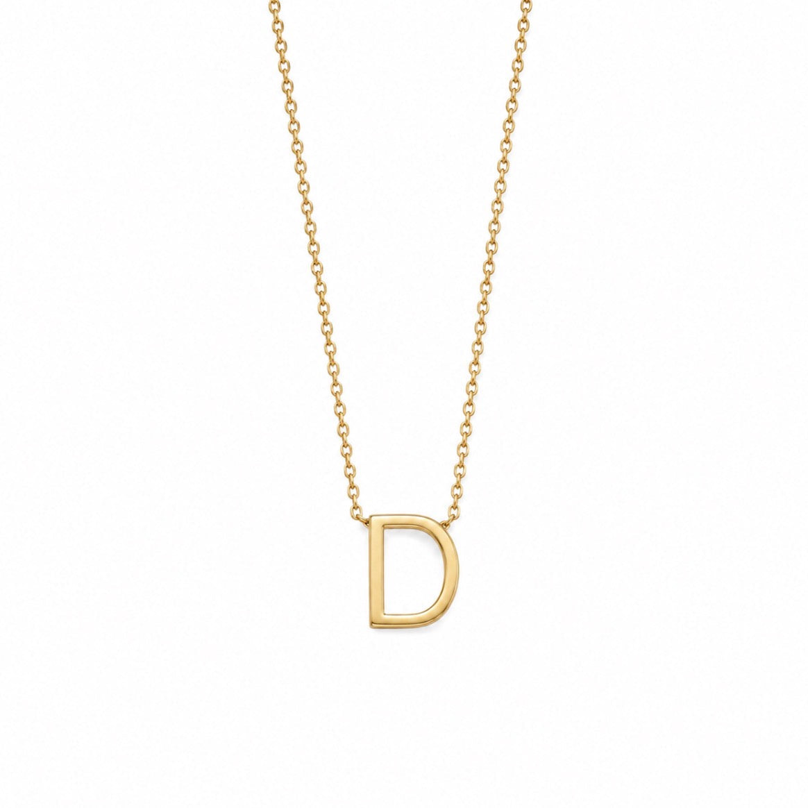A delicate gold chain necklace featuring a polished, open capital letter 'D' pendant, shown against a solid white background.