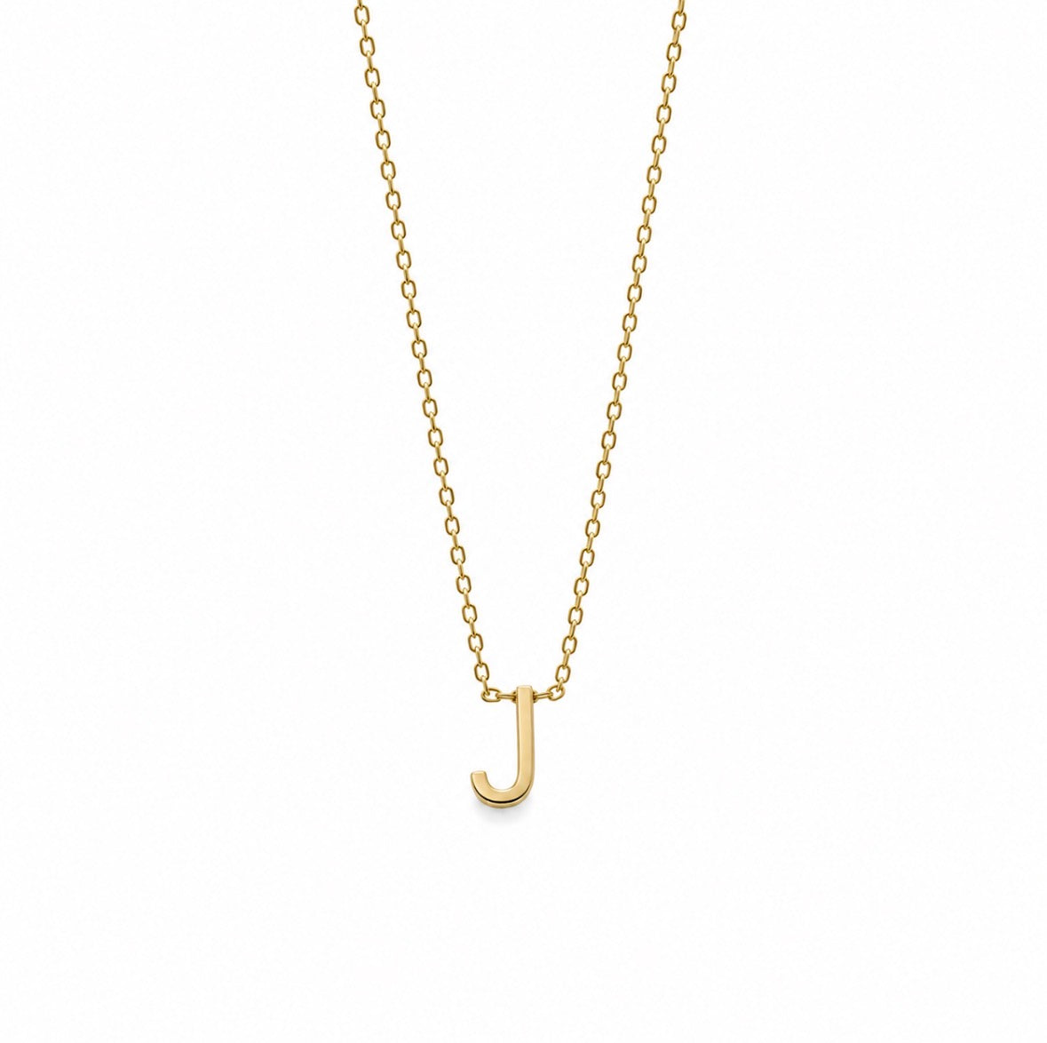 A delicate gold chain necklace featuring a small, polished letter 'J' pendant, presented on a clean white background.