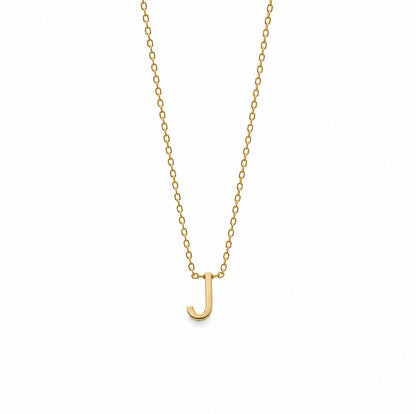 A delicate gold chain necklace featuring a small, polished letter 'J' pendant, presented on a clean white background.