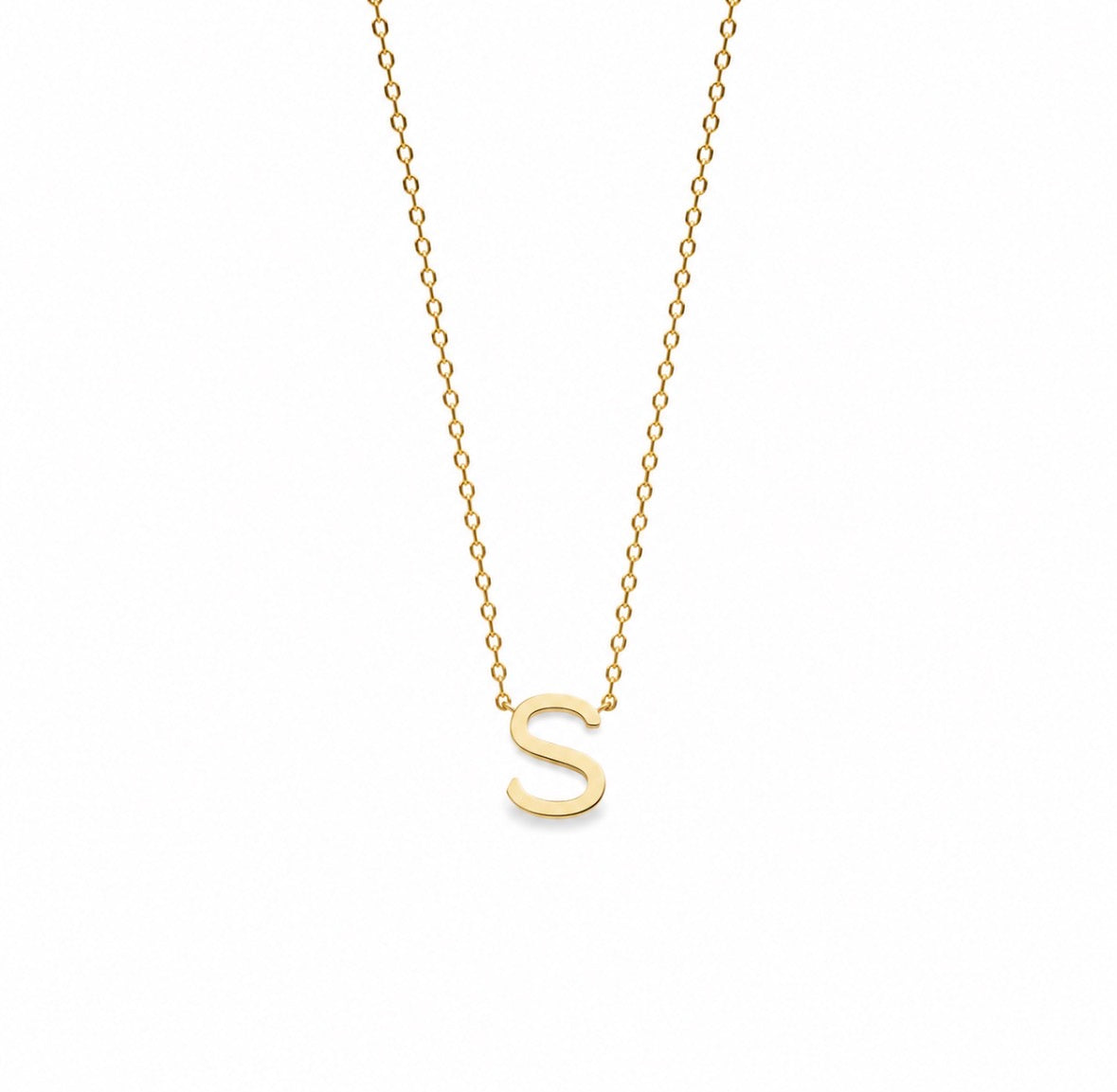 A delicate gold chain necklace featuring a polished, lowercase-style capital letter 'S' pendant, shown against a solid white background.