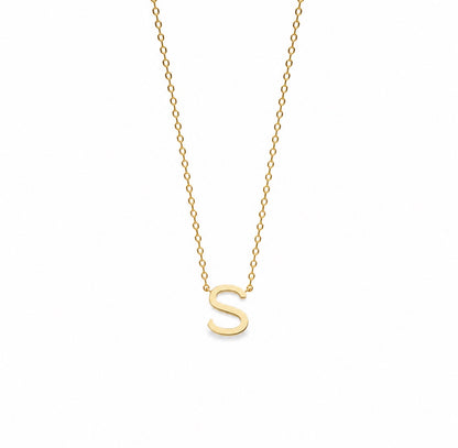 A delicate gold chain necklace featuring a polished, lowercase-style capital letter 'S' pendant, shown against a solid white background.
