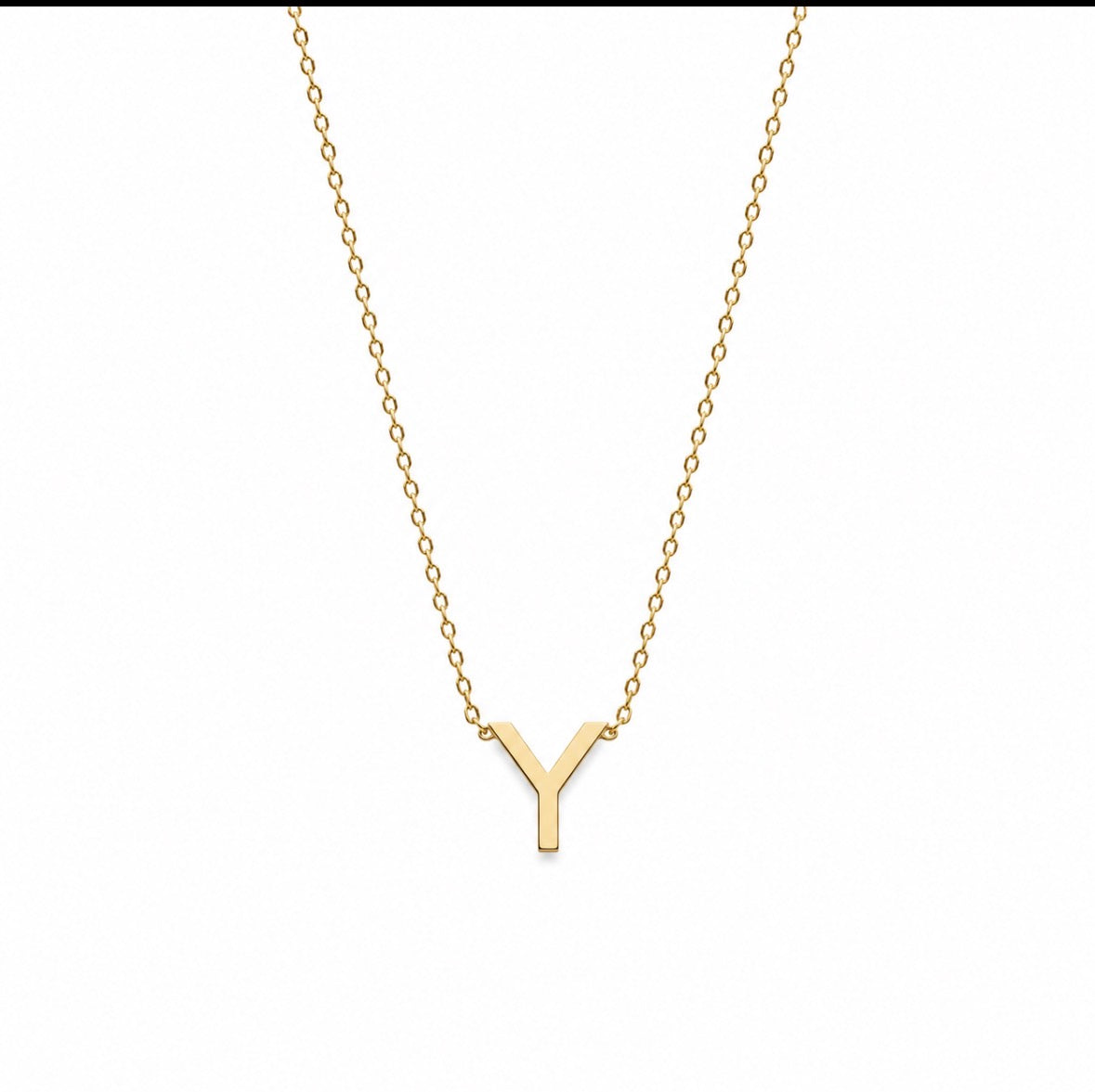 A delicate gold chain necklace featuring a polished gold initial pendant 'Y', displayed against a solid white background.