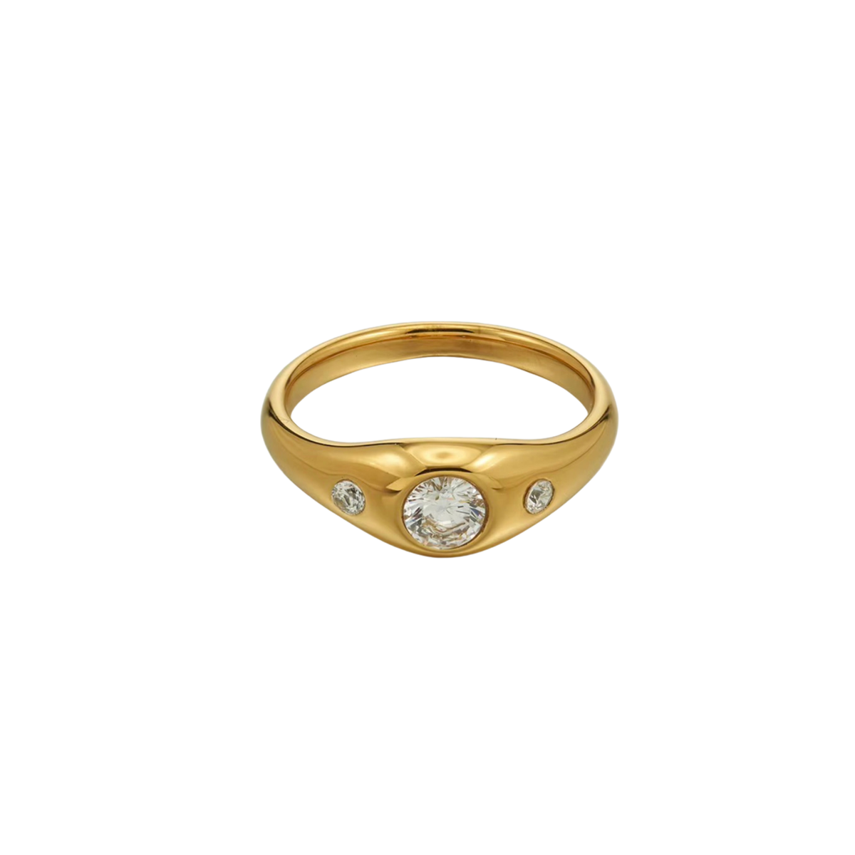 A gold signet-style ring featuring a central round clear gemstone flanked by two smaller side stones, set against a plain white background.