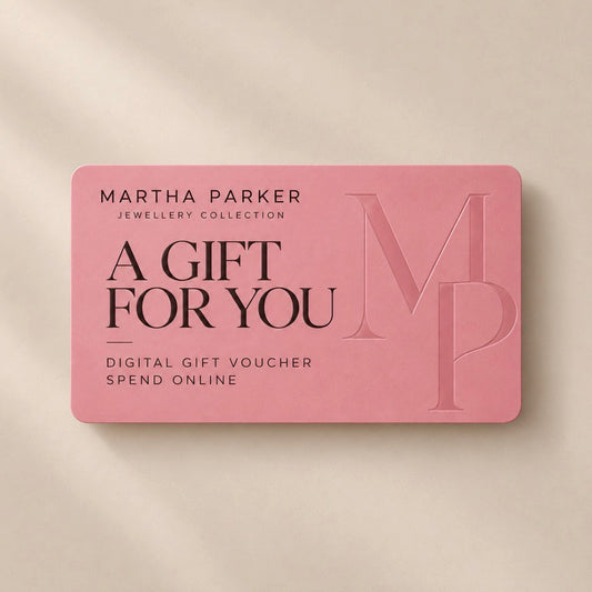 A pink rectangular gift voucher card with rounded corners from Martha Parker Jewellery Collection, reading 'A GIFT FOR YOU' and 'DIGITAL GIFT VOUCHER SPEND ONLINE,' shown on a warm beige background.