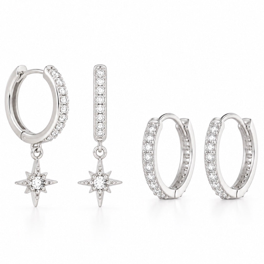 A set of silver-toned hoop earrings with clear pavé stones and dangling starburst charms, shown in multiple views on a white background.
