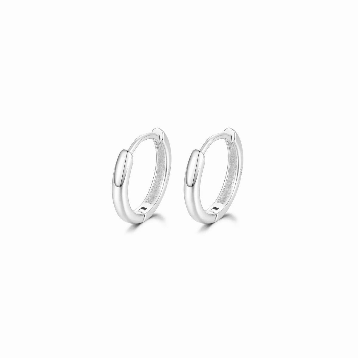 Pair of silver hoop earrings on a white background