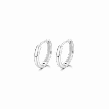 Pair of silver hoop earrings on a white background
