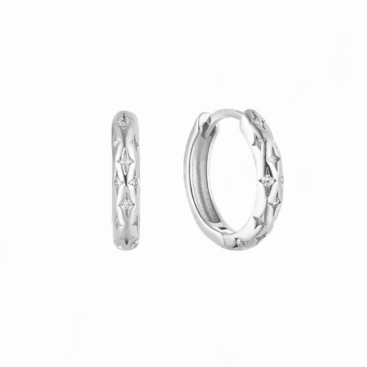 Sterling silver thin cosmic huggie hoops with engraved stars and cubic zirconia stones 