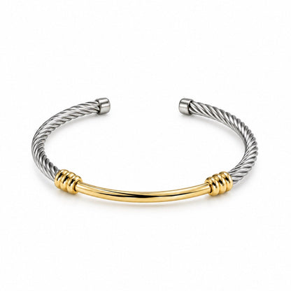A two-tone cable-style cuff bracelet featuring a silver-toned twisted wire design and a central polished gold-toned bar, accented with wrapped gold details on each end, shown on a plain white background.