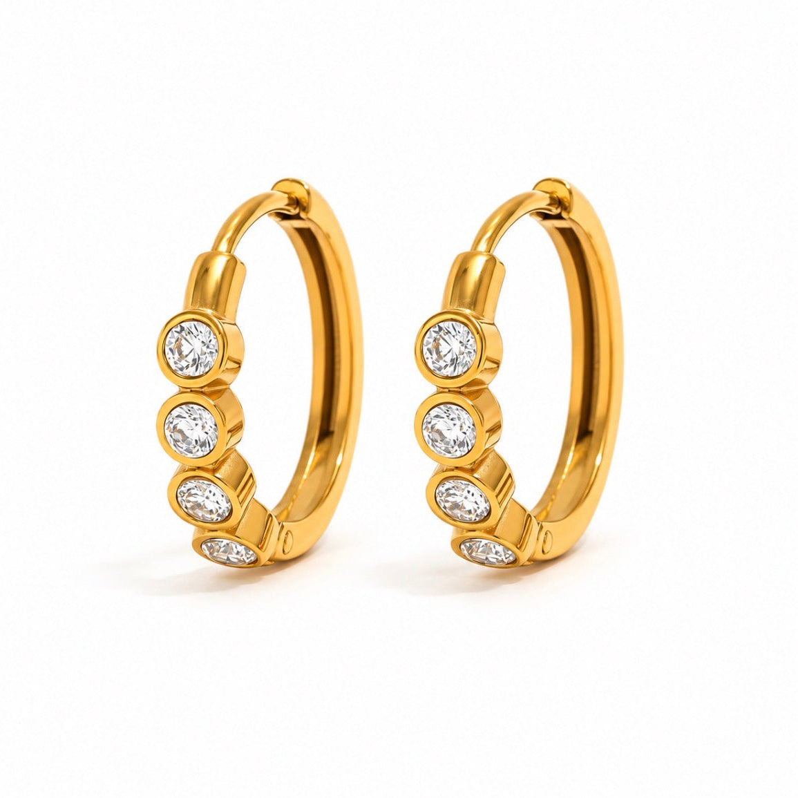 A pair of gold hoop earrings, each adorned with four round-cut clear gemstones in bezel settings, displayed on a clean white background.