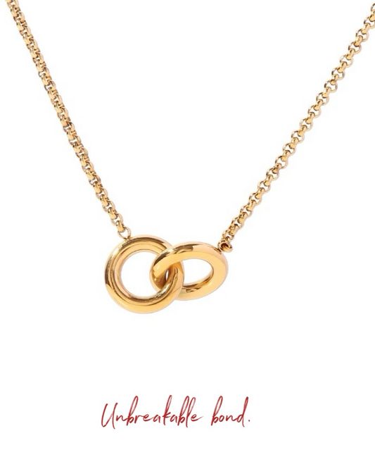 A gold-plated stainless steel necklace featuring two interlocking circles