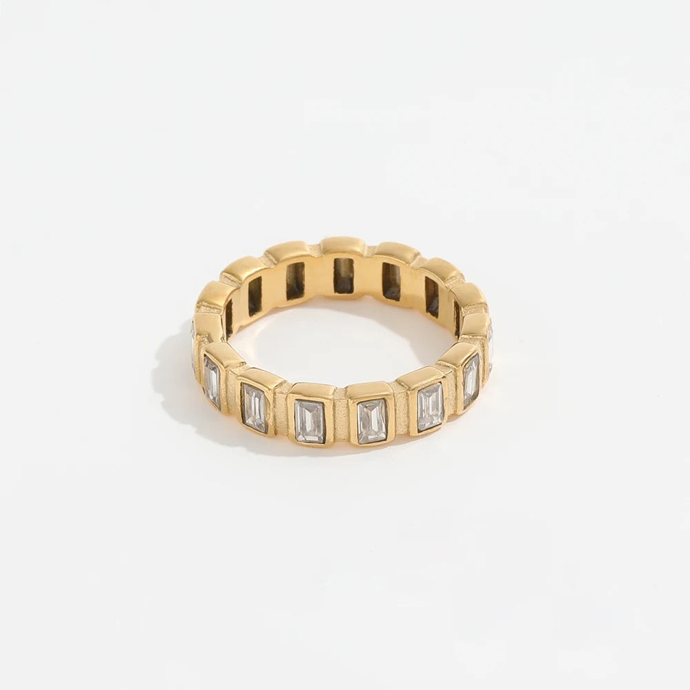 A gold-plated band ring with zirconia stones set around its circumference.