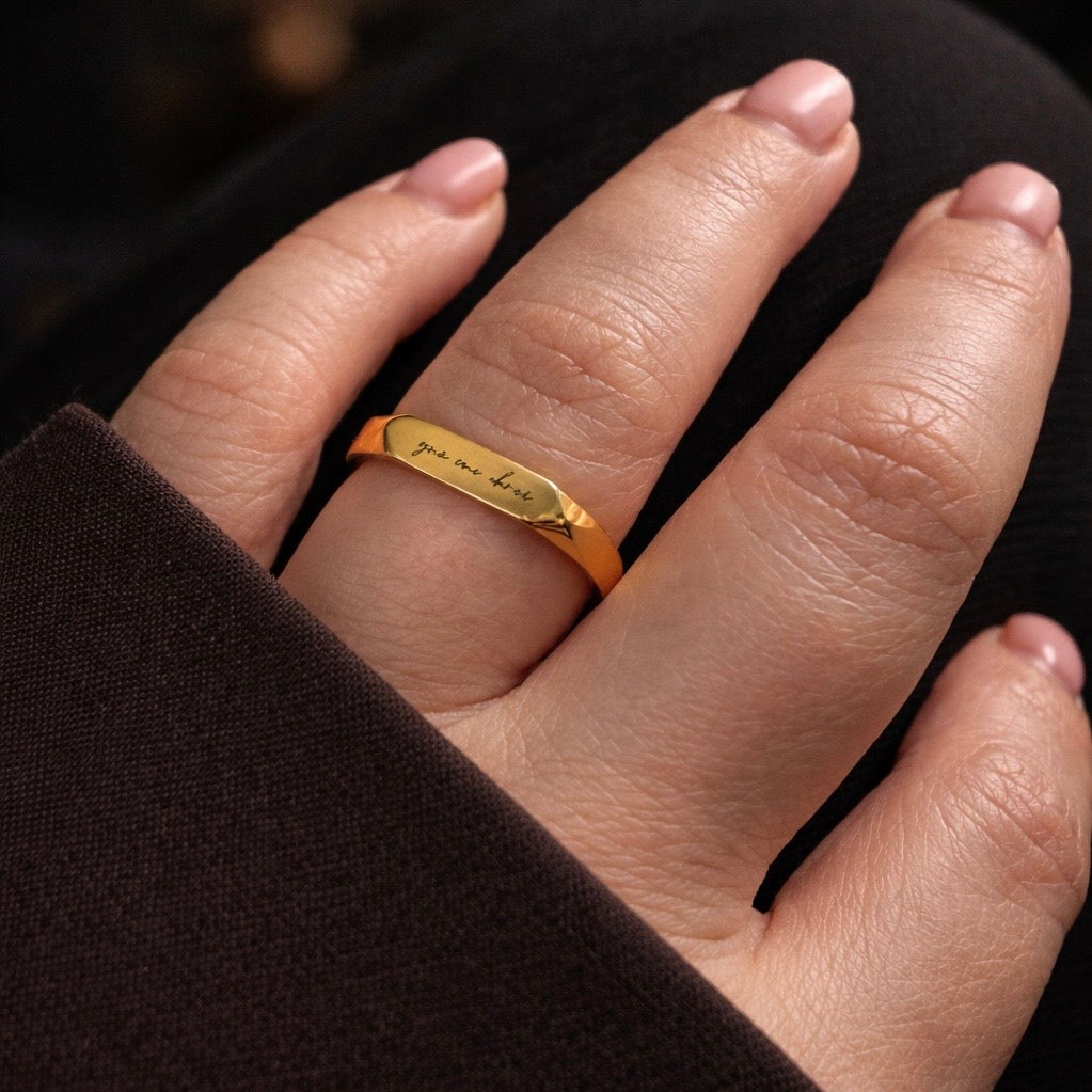 Irish love ring on models finger showing lightly engraved phrase grá mo chroí