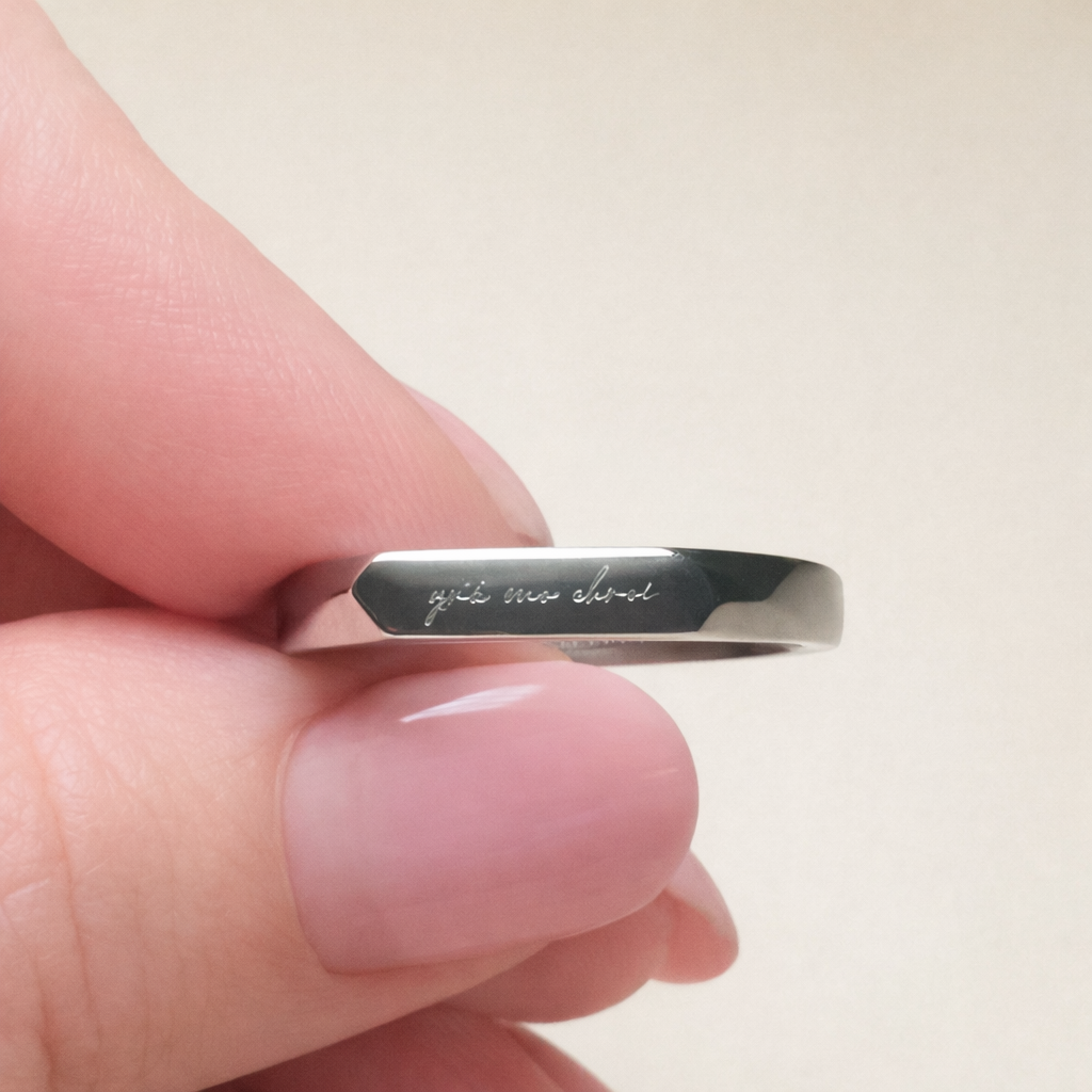 up close silver stainless steel ring with a light engaved irish phrase grá mo chroí meaning love of my heart