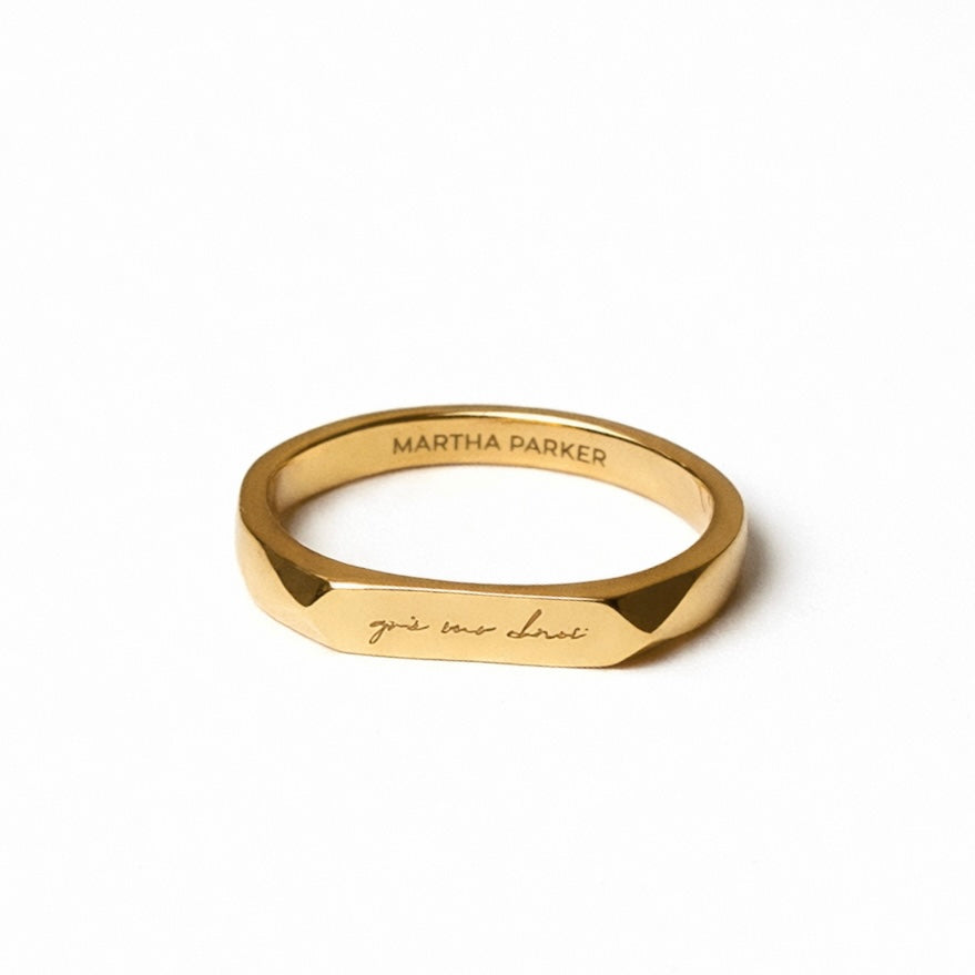 Gold stainless steel ring with a light engraved Irish phrase grá mo chroí meaning love of my heart with branding name Martha Parker on inside of band 