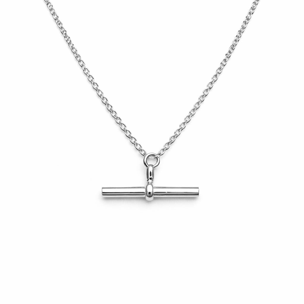 Silver necklace with a bar pendant on a white background