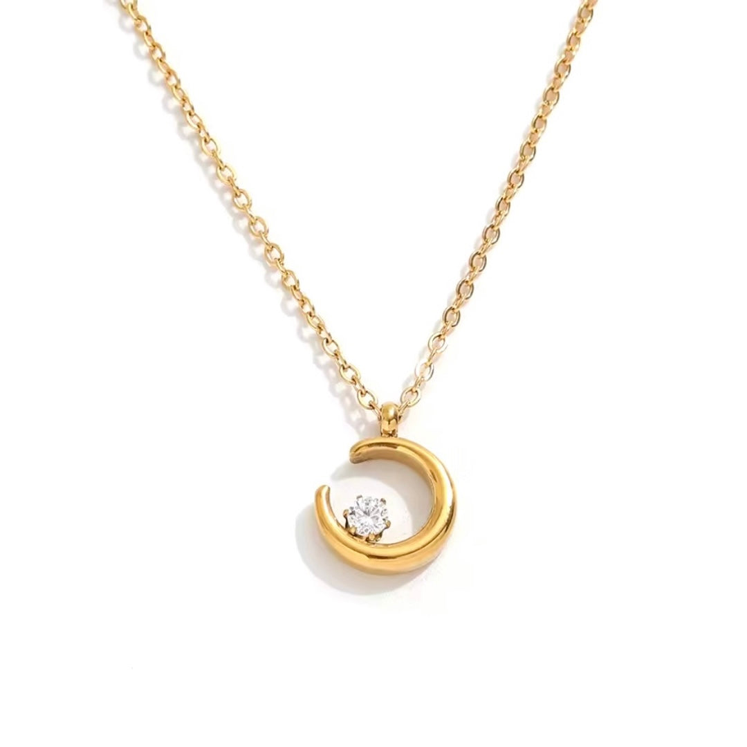 A gold-plated stainless steel necklace with a crescent moon and a central cubic zirconia pendant.