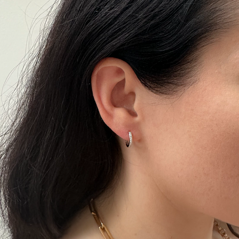 model wearing sterling silver full cubic zirconia pave stone hoop earring 